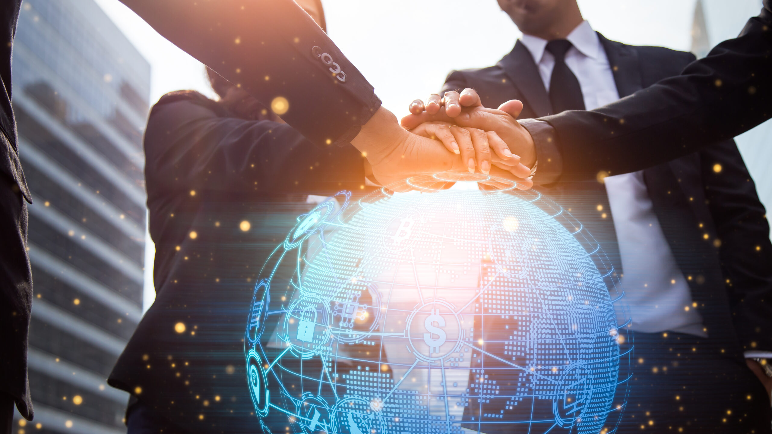 Close up of businessmen shaking hands on a globe.